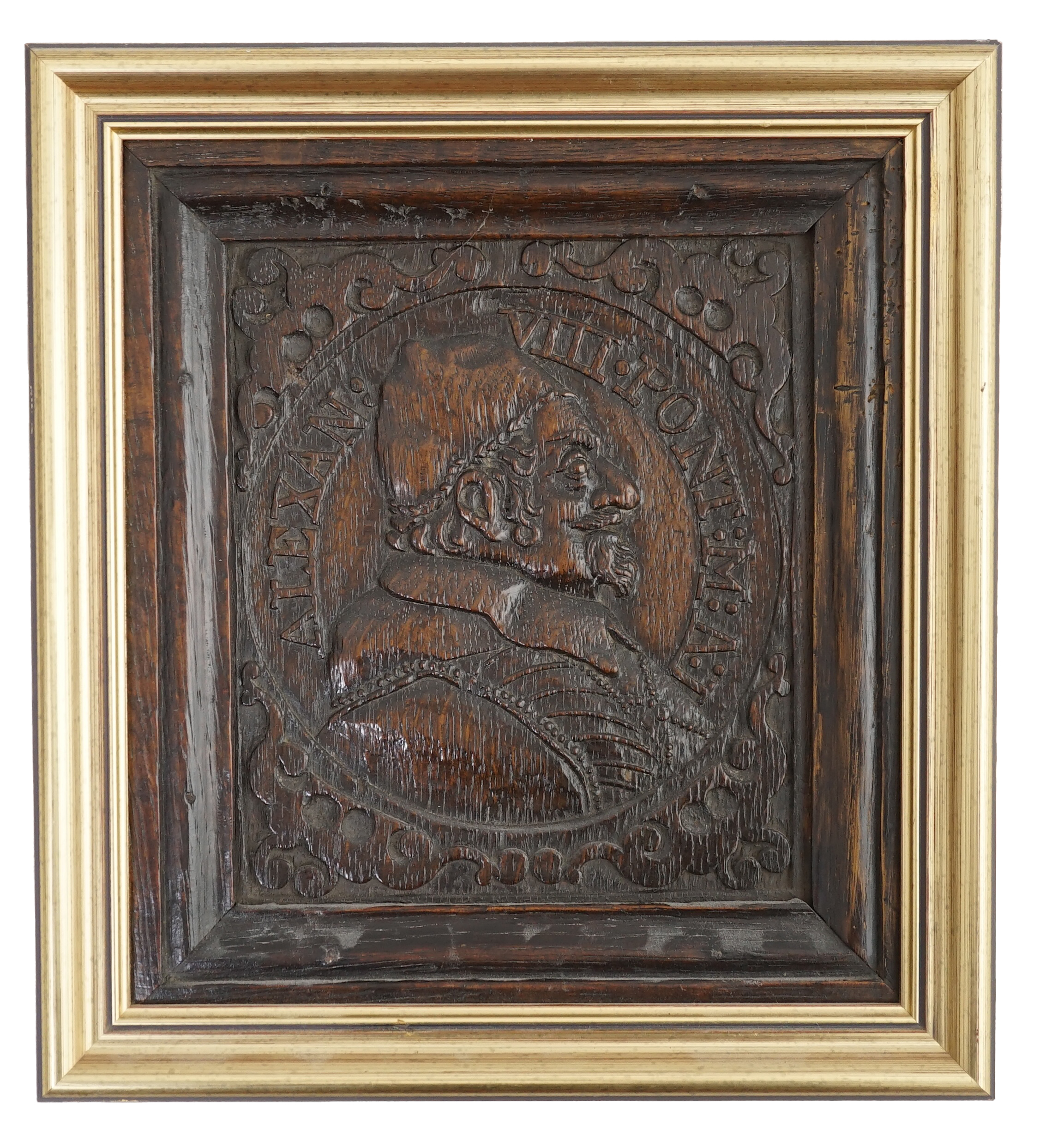 A 17th century oak panel carved with a relief portrait of Pope Alexander VII